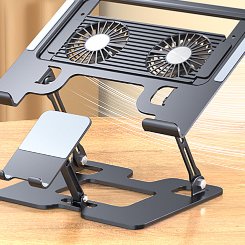 Close view of a dark laptop stand with two round fans and a phone holder on a wooden desk