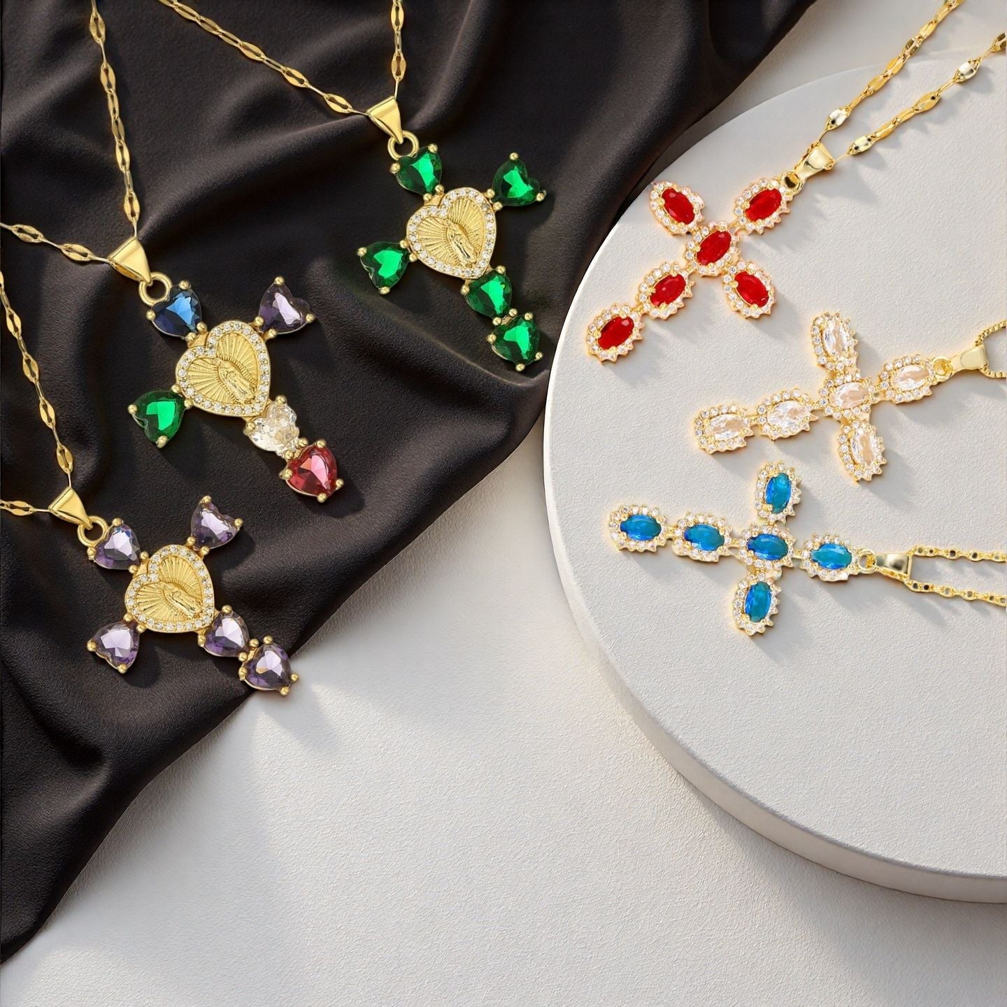 Colored cubic zirconia cross pendant necklaces with a central medallion on dark satin