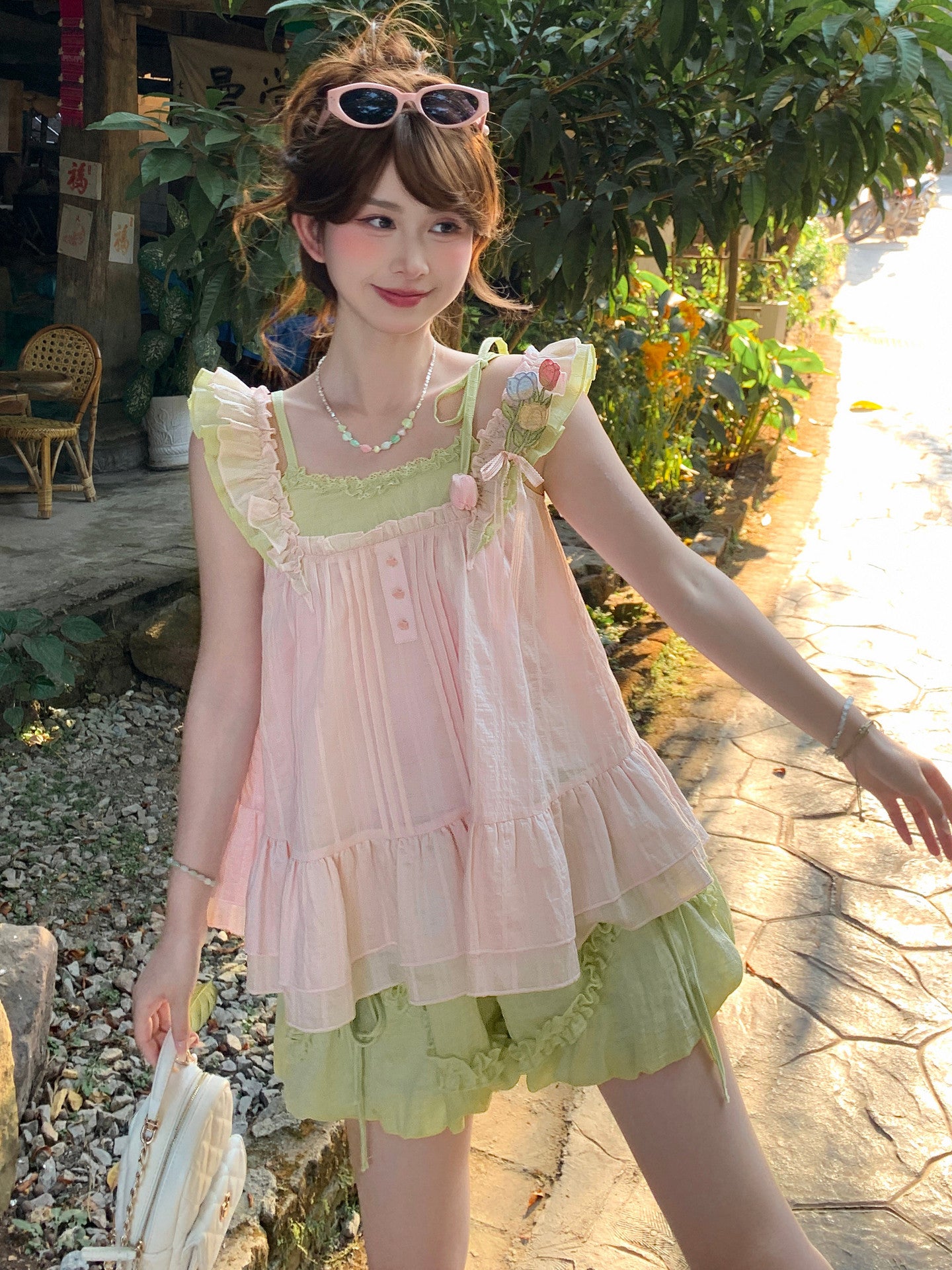 Angled styling shot of the floral top and matching shorts worn as an outfit