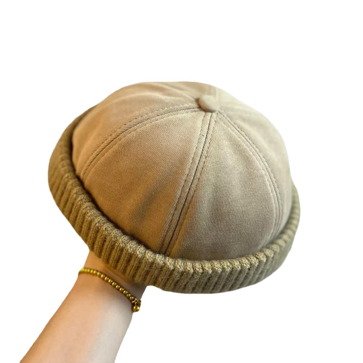 Washed khaki brimless beanie showing the six panel dome crown
