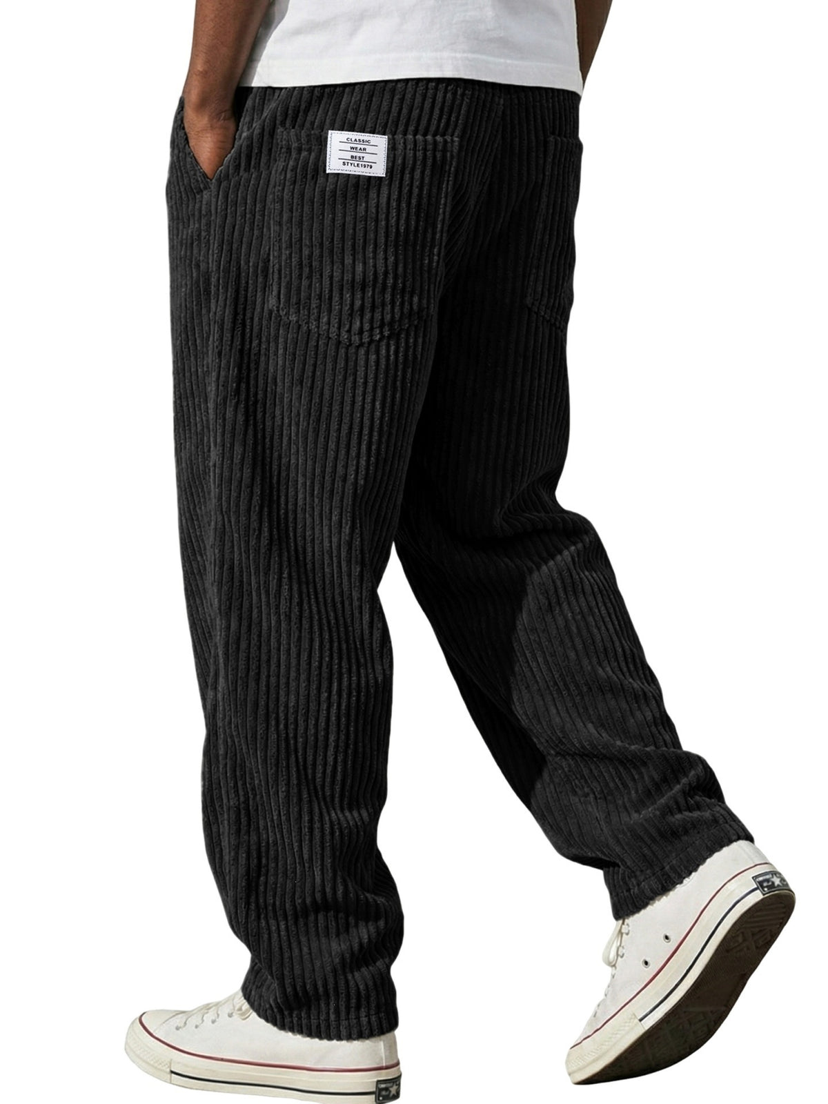 Close view of the deep vertical corduroy wales woven into the soft trouser fabric