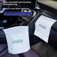 Two white car trash bags, one standing on a seat and one stuck to a dashboard panel, printed Vertical Bin bag