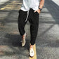 Black ribbed corduroy pants with drawstring waist and thigh pockets, photo used for the Black XL option