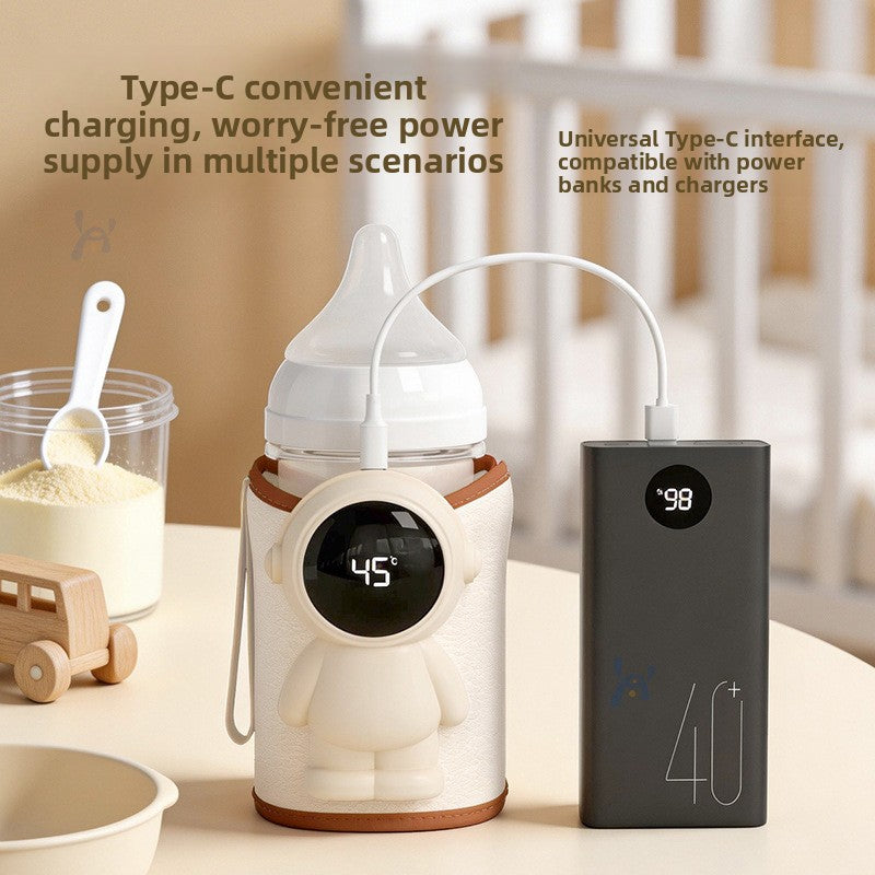 Bottle warmer sleeve on a baby bottle charging through a Type-C cable from a power bank, beside a milk powder jar