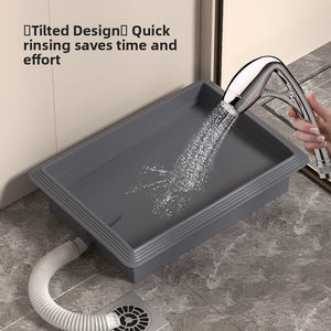 Indoor dog toilet tray with direct drain connection shown from the front in grey plastic