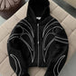 Close view of white line embroidery on the shoulder of a black hoodie
