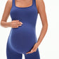 Dark grey maternity ribbed romper worn by a pregnant model on a chair