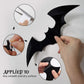 Group of black PVC bat wall stickers in a drifting cloud across a white wall
