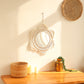 Front view of the round decorative wall mirror with handwoven frame and tassels