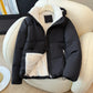 Close view of a zippered front pocket on the quilted hooded puffer jacket