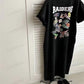 Long washed black T-shirt dress on hanger with varsity text and layered badge back print