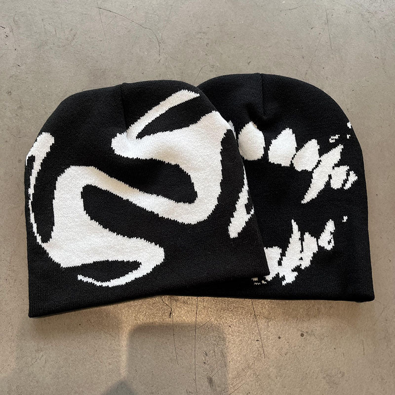Ghost pattern knit winter beanie in gray shown on a plain surface