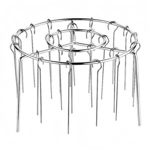Empty polished stainless steel air fryer skewer rack with rows of hook needles