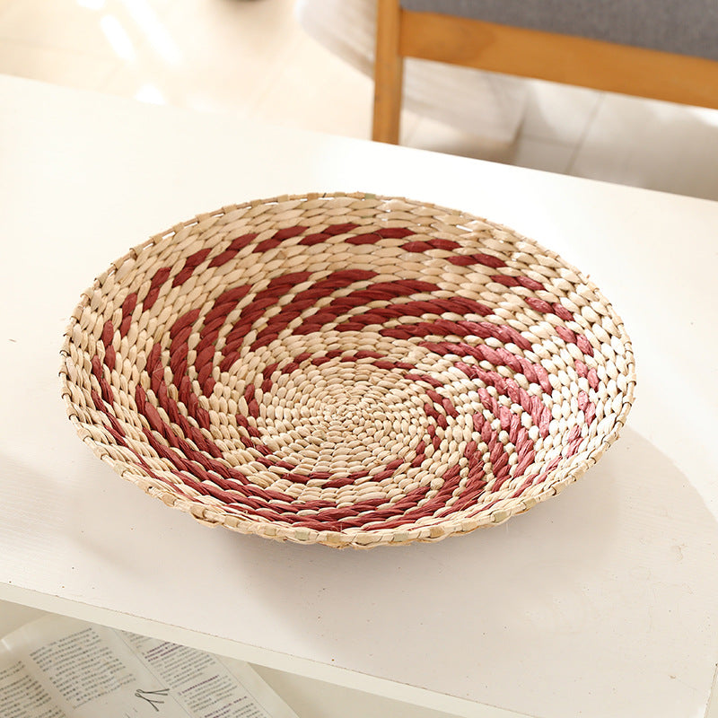 Natural straw woven wall ornament with a raised handmade spiral texture