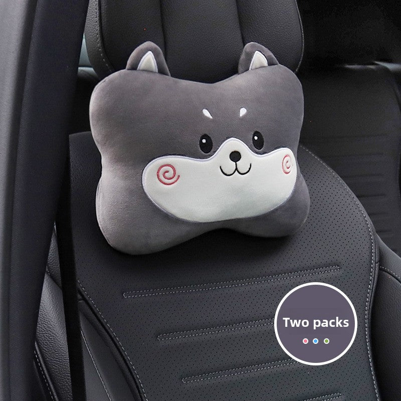 Gray dog cartoon headrest pillow with a spiral cheek mark on a black car seat, two pack badge