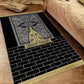 Plush velvet Islamic prayer mat with a printed ornamental design and fringed ends on a wood floor