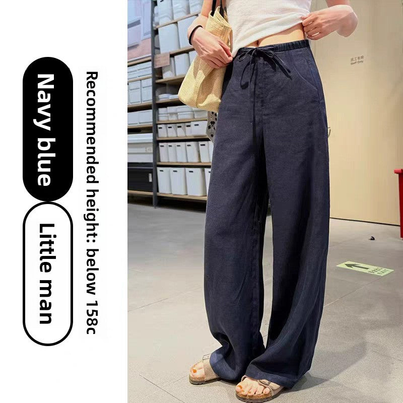 Womens high waist wide leg linen blend drawstring trousers, front view on a model styled with flat sandals