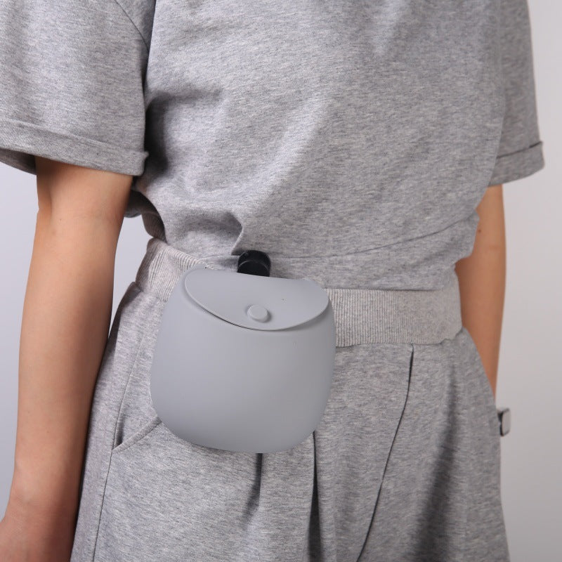 Silicone dog treat pouch clipped to a waistband, worn hands free on the hip
