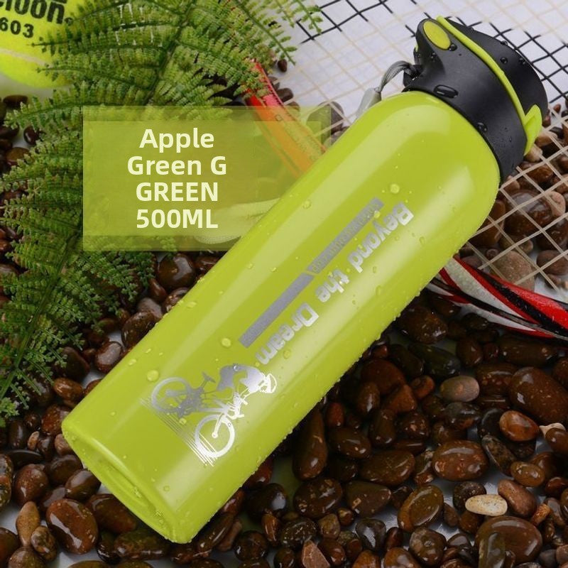 Apple green stainless steel sports bottle with black flip lid lying on coffee beans and fern leaves, green option
