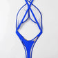Cobalt blue one piece swimsuit laid flat to show the crossover straps and midriff cutout