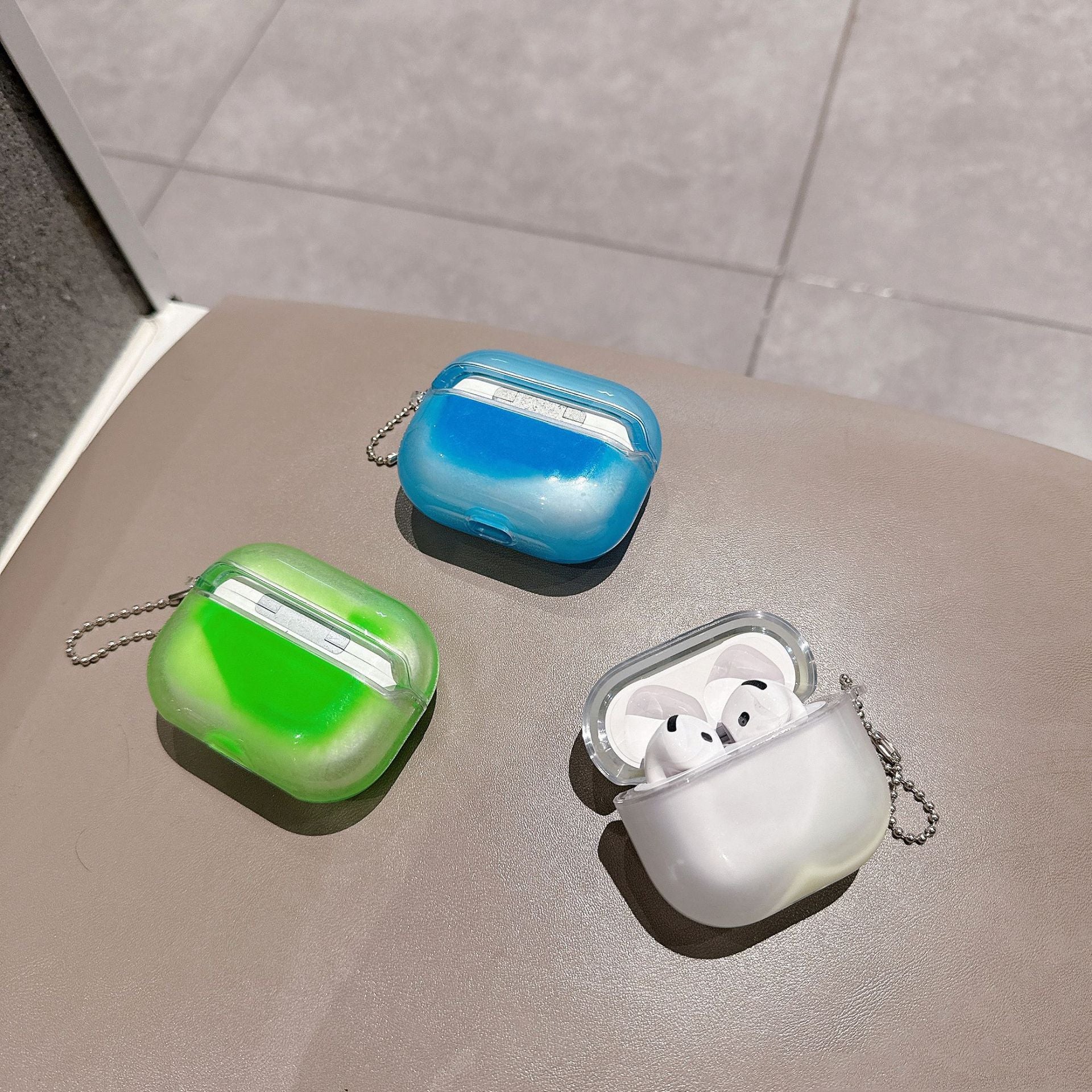 Blue and green covers with white case compatible with AirPods