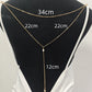 Layered rhinestone back necklace draped over a black jewelry display stand