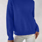 Blue half-high neck pullover sweater with long sleeves worn with white trousers, size XXL variant image