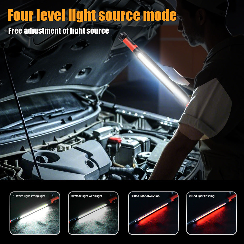 COB LED work light lighting a car engine bay, held over the open hood