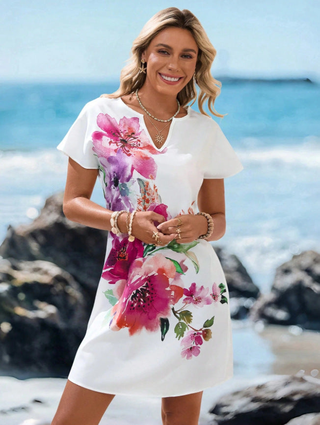 V-neck starfish and seahorse print A-line beach dress, full length on a model at the beach