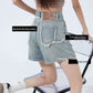 Rear angle of mid-thigh denim shorts showing frayed raw-edge back patch pockets
