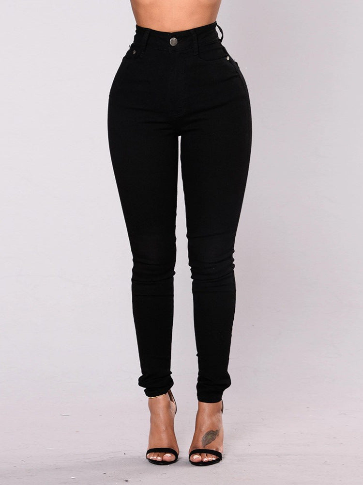 Black high waist skinny jeans, front view on model with black ankle strap heels