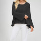 Round neck cable knit pullover with an open braided stitch and boxy relaxed body