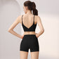 Back view of a woman in a black V-back sports bra and black high-waist shorts set, size S option