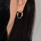 Top down view of the hoops beside a small ceramic ring dish