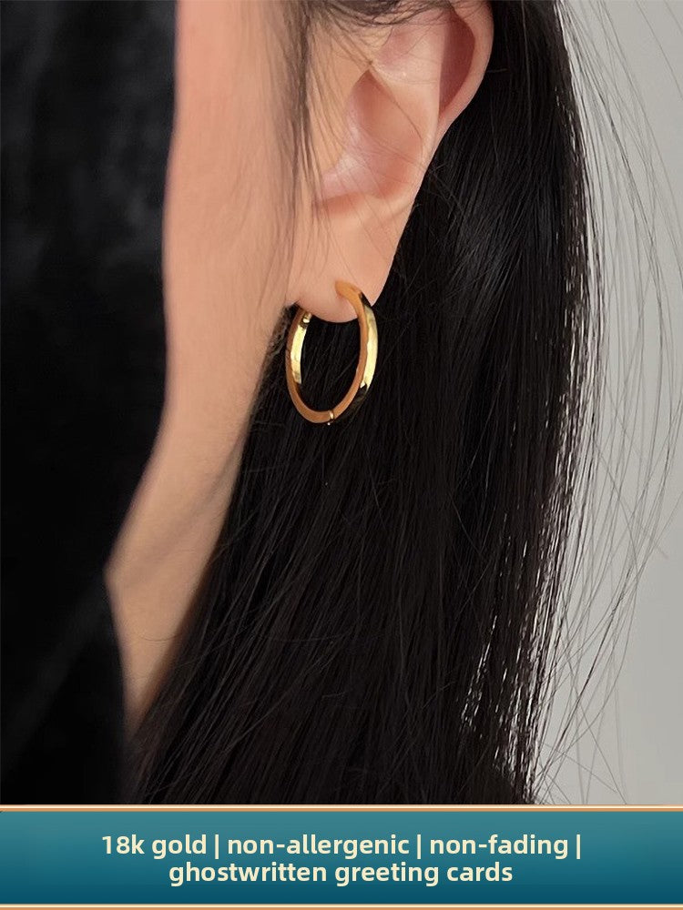 Top down view of the hoops beside a small ceramic ring dish