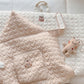 Coffee quilted baby cape folded with hood and front hand pocket visible