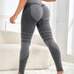 Womens high waist seamless yoga leggings on a model, scrunch back and stretch knit