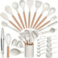 White silicone kitchen utensil set with beech handles arranged in an arc around the matching crock