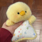Palm sized squishy bean bag plush animal toy with brushed faux fur and a printed cotton apron