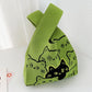 Knitted polyester handbag with an open top and a two tone jacquard motif