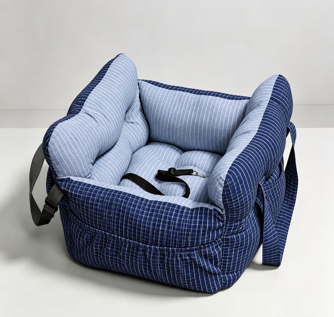 Padded car seat pet bed with raised bolster walls, carry handles and an inner clip showing the carry handles on the side