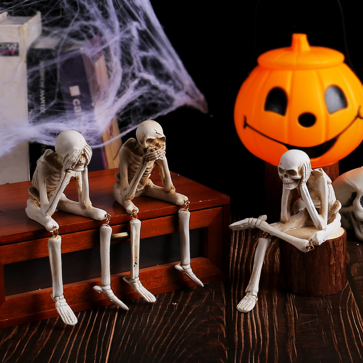 Hear no evil resin skeleton figurine covering its ears