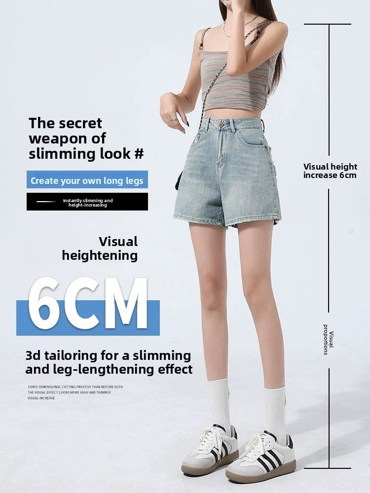A-line denim shorts flaring to a raw frayed hem at the mid-thigh on a model