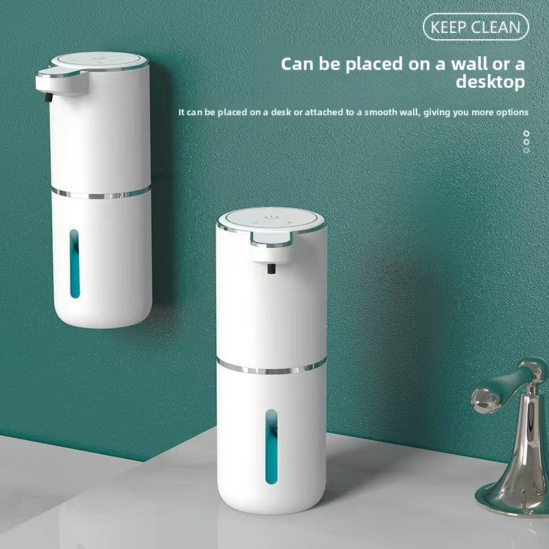 White foaming soap dispenser mounted on a teal wall and standing on a counter