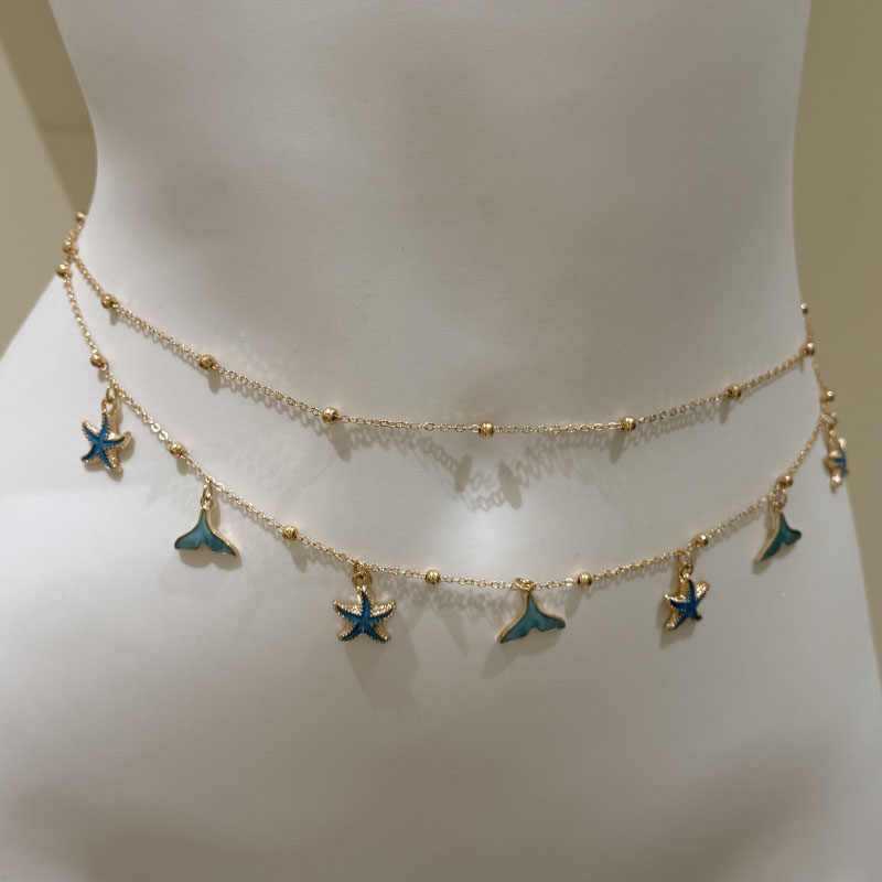 Double layer gold waist chain worn low on the hips