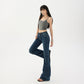Model wearing dark vintage wash flared jeans, side pose showing the slim leg and clean flare from the knee