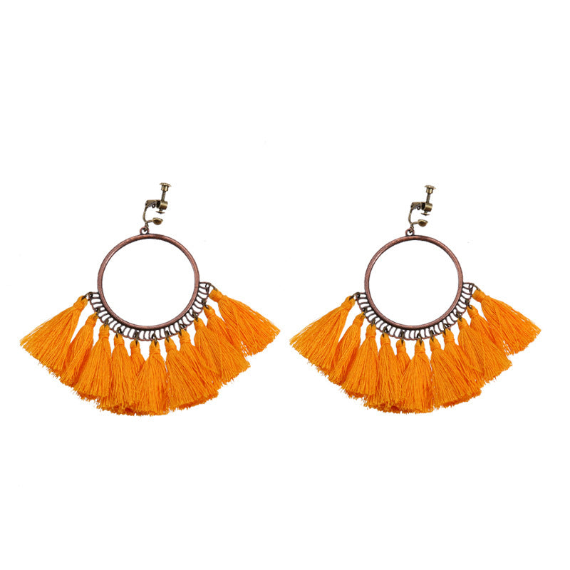 Handmade bohemian clip-on earrings with tassel and bead drop detail, zinc alloy frame, studio shot on white background