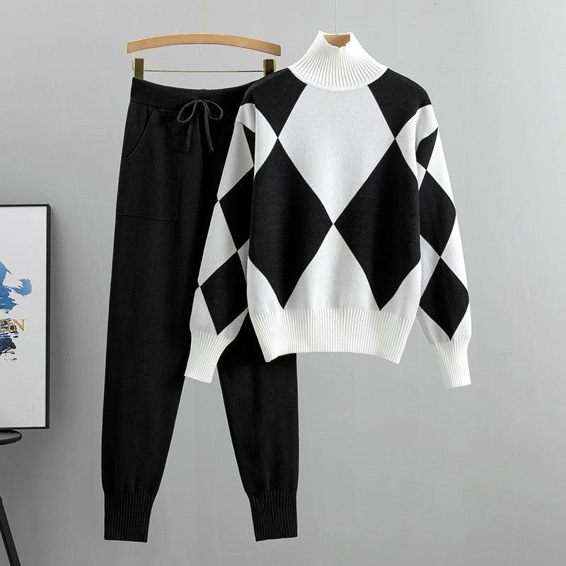 Black argyle knit sweater and jogger pants set with white panels on a hanger, size XL option