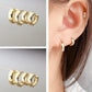 Gold hoop earrings stored in an open jewelry box