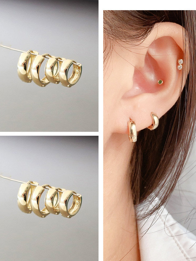 Gold hoop earrings stored in an open jewelry box